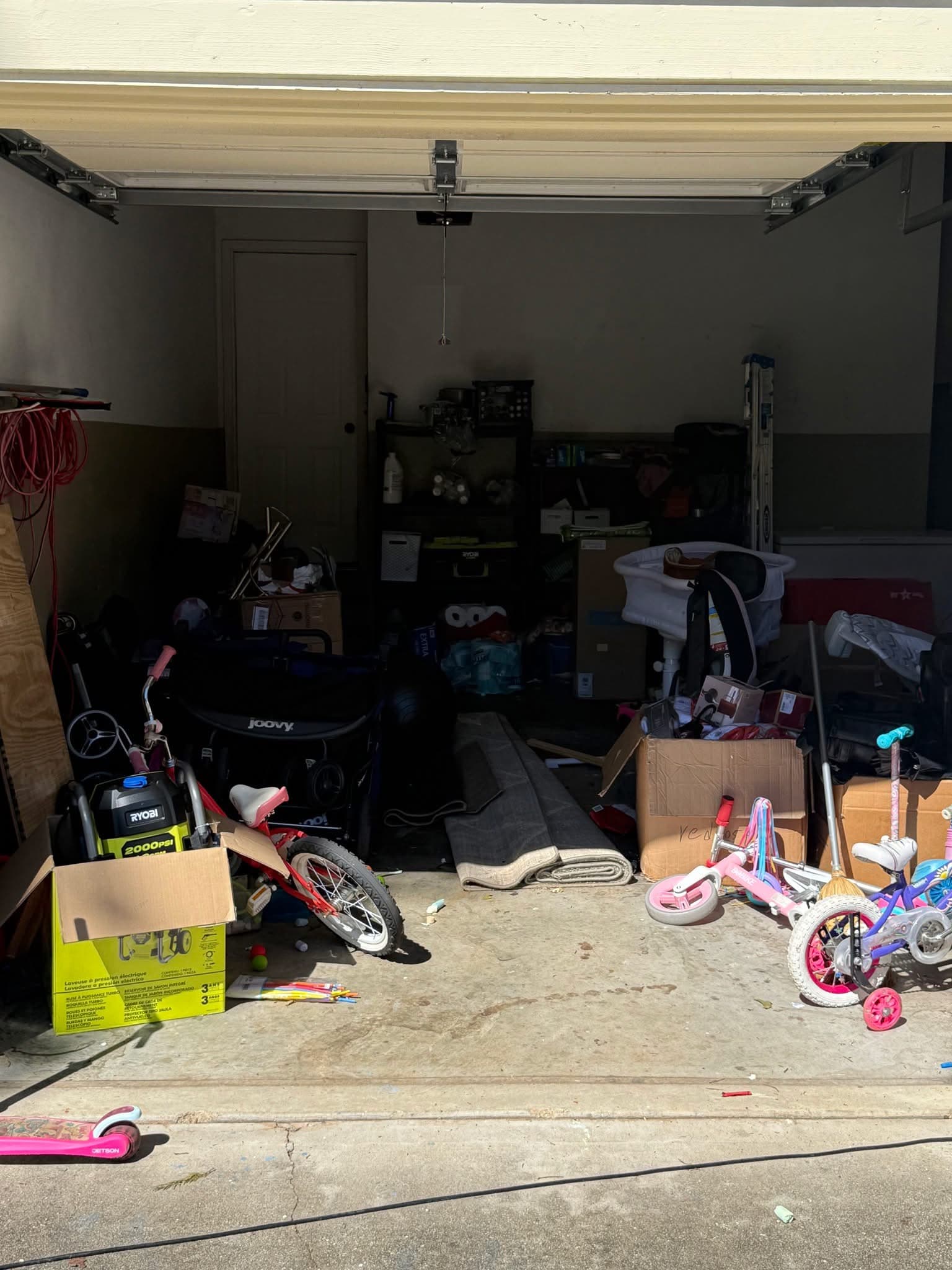 Garage cleanout with bikes and boxes